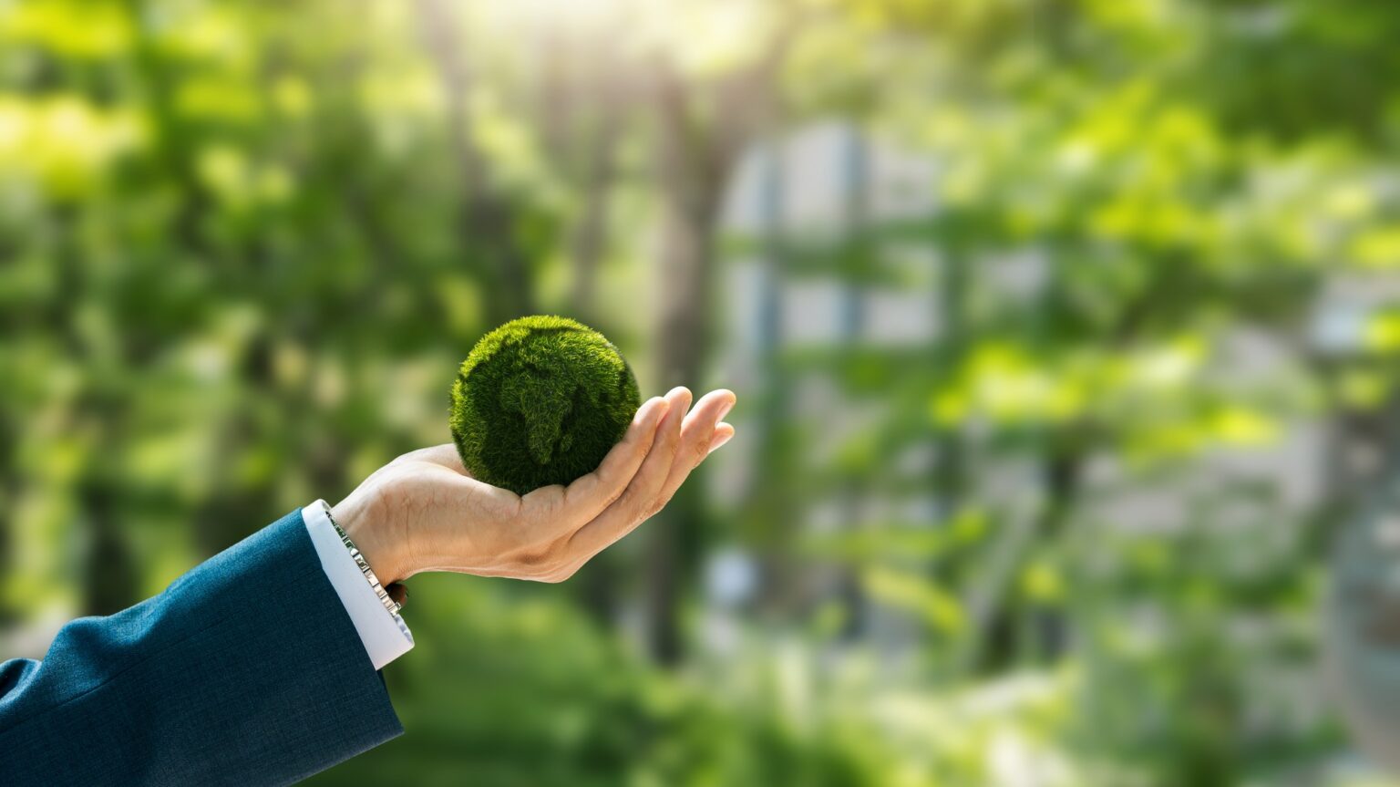 Environmental concept. Green globe in the hands of a businessman with icons. Green future goals